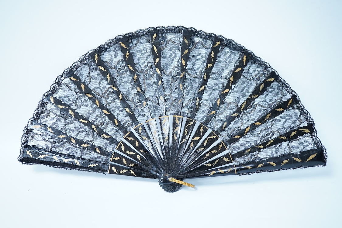 A collection of 19th century and later fans to include a black lacquered and lace example and a hand painted floral example